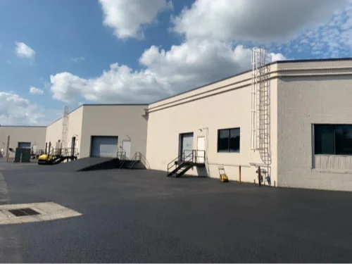 Cracked asphalt and potholes in a retail parking lot in Lehigh Valley, PA