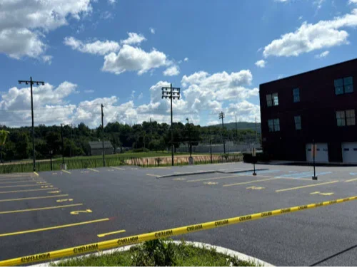 Commercial paving inspector performing a parking lot inspection in Lehigh Valley retail plaza