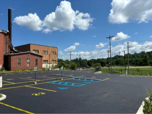 Retail parking lot with clear traffic flow, arrows, and cars moving safely in Alburtis, PA