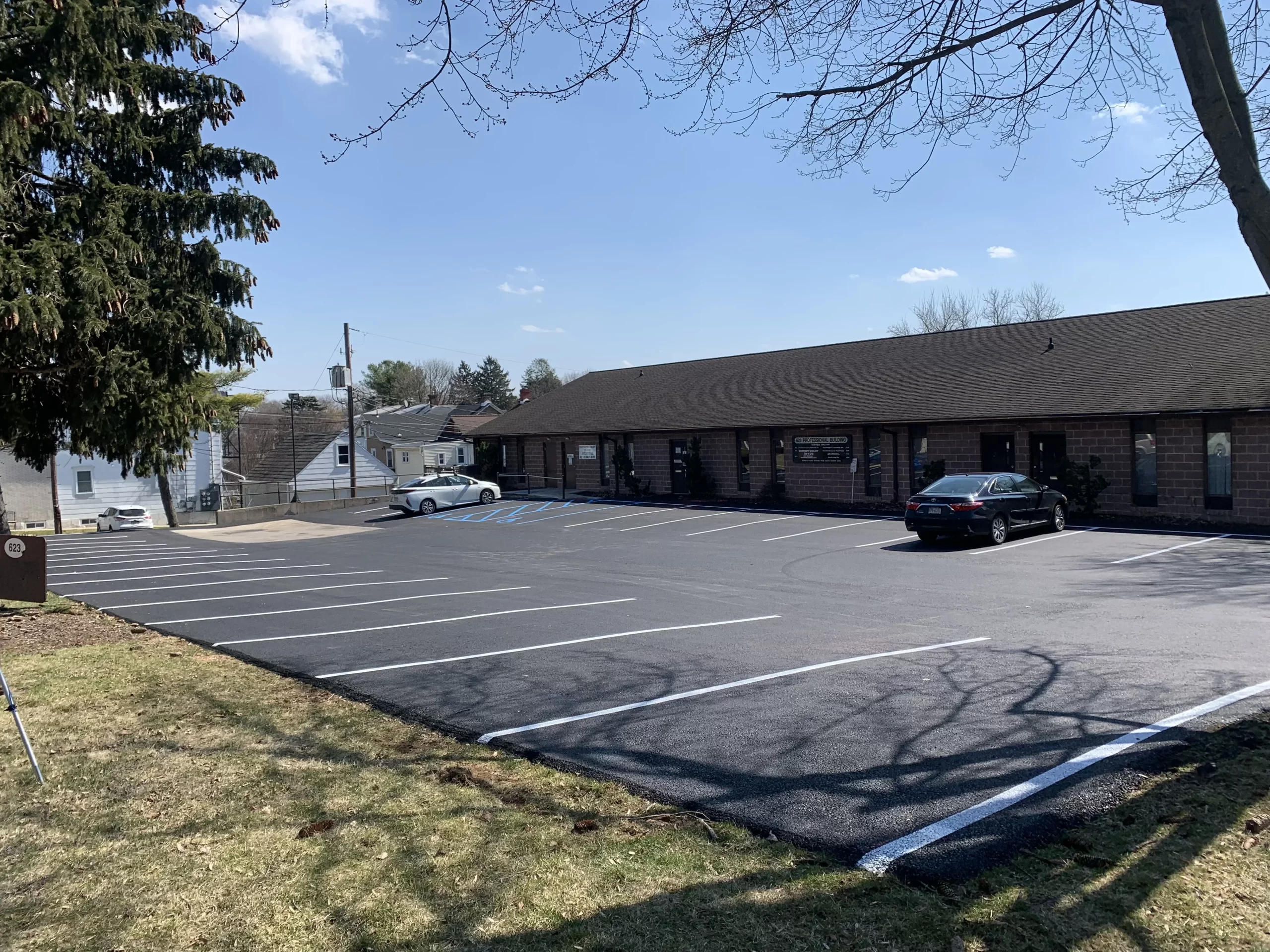Commercial property case study with property manager and paving supervisor shaking hands, showing before and after results of parking lot paving